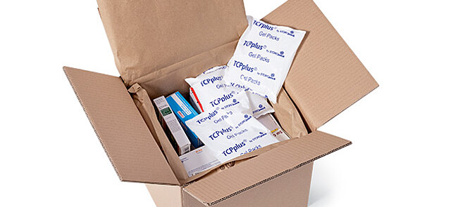 
			Image of an open shipping box containing medications and ice packs.