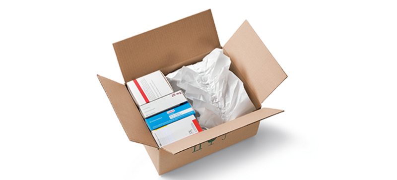 
		  A cardboard box containing medications and white paper cushioning